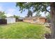 Large backyard with a spacious deck, built-in seating and storage shed at 4629 Estes St, Wheat Ridge, CO 80033