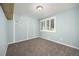 Bedroom with a carpet, light blue walls, white trim, a ceiling light, and a window with white shutters at 4629 Estes St, Wheat Ridge, CO 80033