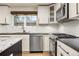 Kitchen showcasing stainless steel appliances, white subway tile backsplash, and sleek countertops at 4629 Estes St, Wheat Ridge, CO 80033