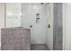 Modern shower featuring glass enclosure and gray mosaic tile at 4629 Estes St, Wheat Ridge, CO 80033