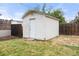 Backyard storage shed with white siding, perfect for storing tools and equipment at 4629 Estes St, Wheat Ridge, CO 80033