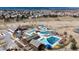 Aerial view of a community clubhouse with a pool, water slides, and splashpad, surrounded by a neighborhood at 3129 Open Sky Way, Castle Rock, CO 80109