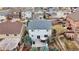 Aerial view of a light grey home with a spacious fenced yard, featuring a patio area with seating and landscaping at 3129 Open Sky Way, Castle Rock, CO 80109