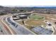 Expansive aerial view of a school complex featuring modern facilities and a well-equipped playground at 3129 Open Sky Way, Castle Rock, CO 80109