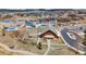 Aerial view of a community clubhouse with a pool, water slides, and splashpad surrounded by landscaping and walking paths at 3129 Open Sky Way, Castle Rock, CO 80109