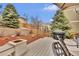 Backyard deck with a grill, outdoor seating, a pergola, and retaining walls at 3129 Open Sky Way, Castle Rock, CO 80109