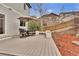 Outdoor seating area with a patio umbrella and wood-look deck at 3129 Open Sky Way, Castle Rock, CO 80109