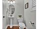 Charming powder room features a pedestal sink, toilet, bronze fixtures and natural light from window at 3129 Open Sky Way, Castle Rock, CO 80109