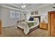 Calm bedroom features a bed with decorative pillows, natural nightstands and neutral decor at 3129 Open Sky Way, Castle Rock, CO 80109