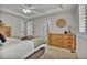 Spacious bedroom with hardwood dresser, carpeted floor and an open doorway for easy access at 3129 Open Sky Way, Castle Rock, CO 80109