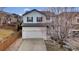 Charming two-story home with a well-manicured lawn, inviting curb appeal, and attached two car garage at 3129 Open Sky Way, Castle Rock, CO 80109