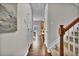 Inviting hallway with beautiful hardwood floors and stairway to the upper level at 3129 Open Sky Way, Castle Rock, CO 80109