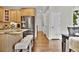 Kitchen area with stainless steel refrigerator, granite counters, and a hallway with white paneled doors at 3129 Open Sky Way, Castle Rock, CO 80109