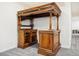 Stunning wet bar featuring dark wood and pillars, perfect for entertaining guests in style at 5285 E State Highway 86, Franktown, CO 80116