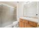 Bright bathroom featuring a glass-enclosed shower, vanity with cabinets, and a large mirror for added light at 5285 E State Highway 86, Franktown, CO 80116
