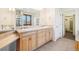 Bright bathroom features double vanity, tile floors, and walk-in closet access at 5285 E State Highway 86, Franktown, CO 80116