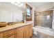 Updated bathroom features a glass shower, tile surround and wood vanity with natural light at 5285 E State Highway 86, Franktown, CO 80116