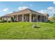 Spacious home exterior with a large, well-manicured lawn and inviting covered patio area at 5285 E State Highway 86, Franktown, CO 80116