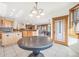Bright and airy kitchen featuring modern lighting, wood cabinetry, and open floor plan at 5285 E State Highway 86, Franktown, CO 80116