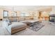 Spacious living room with an open layout, fireplace, bar area, and ample natural light at 5285 E State Highway 86, Franktown, CO 80116