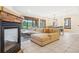 Cozy living room showcasing a fireplace, comfortable seating, and a seamless connection to the dining area at 5285 E State Highway 86, Franktown, CO 80116