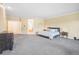 Large primary bedroom features neutral tones, soft carpet, and access to a luxurious ensuite at 5285 E State Highway 86, Franktown, CO 80116