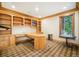 Home office with custom wood built-ins, ample storage, natural light, and a functional layout at 5285 E State Highway 86, Franktown, CO 80116