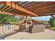 Inviting outdoor kitchen featuring a built-in grill, fireplace, and comfortable seating at 5285 E State Highway 86, Franktown, CO 80116