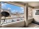 Cozy balcony with black railings offers neighborhood street views and a peek at nearby townhomes on a sunny day at 1509 S Florence Ct # 218, Aurora, CO 80247