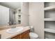 Bathroom featuring updated fixtures, a shower and shelving space for storage at 1509 S Florence Ct # 218, Aurora, CO 80247