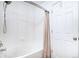 Bright bathroom featuring a tub/shower with white tile and a shower curtain at 1509 S Florence Ct # 218, Aurora, CO 80247
