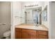 Well-lit bathroom featuring a large mirror and wood cabinetry at 1509 S Florence Ct # 218, Aurora, CO 80247
