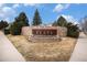 Stone sign for 'The Flats' community set amid manicured landscaping and walkway at 1509 S Florence Ct # 218, Aurora, CO 80247
