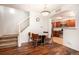 Dining area adjacent to the kitchen and stairs, featuring hardwood floors and modern lighting at 1509 S Florence Ct # 218, Aurora, CO 80247