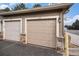Attached two-car garage with stone veneer accents and individual doors leading to the home's exterior at 1509 S Florence Ct # 218, Aurora, CO 80247