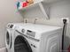 Convenient laundry room equipped with a front loading washer and dryer at 1509 S Florence Ct # 218, Aurora, CO 80247