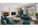 Bright living room with a fireplace, large windows, dark wood floors, and stylish furnishings at 1509 S Florence Ct # 218, Aurora, CO 80247