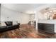Open-concept living room with hardwood floors flowing into the dining and kitchen area at 1509 S Florence Ct # 218, Aurora, CO 80247