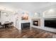 Cozy living room with hardwood floors, a fireplace, and views to the dining and kitchen areas at 1509 S Florence Ct # 218, Aurora, CO 80247