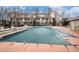 Community swimming pool covered with a secured tarp, surrounded by a fence and a brick-tiled deck at 1509 S Florence Ct # 218, Aurora, CO 80247