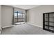 Neutral bedroom with sliding doors to a balcony and a black bookshelf in the corner at 14001 E Marina Dr # 603, Aurora, CO 80014