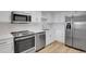 Modern kitchen boasts stainless steel appliances, white cabinets, and sleek countertops at 14001 E Marina Dr # 603, Aurora, CO 80014
