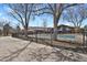 Community pool surrounded by trees and a wrought-iron fence at 14001 E Marina Dr # 603, Aurora, CO 80014