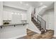 Stylish basement bar area with modern cabinets, countertops, and a staircase leading to the upper level at 6532 S Tempe St, Aurora, CO 80016