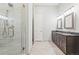Modern bathroom with double vanity, granite countertop, and walk-in shower with textured tile at 6532 S Tempe St, Aurora, CO 80016