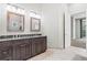 Bright bathroom features a double vanity with granite countertop and decorative mirrors at 6532 S Tempe St, Aurora, CO 80016