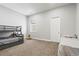 Spacious bedroom featuring a bunk bed, single bed, plush carpet, and a sun-filled window at 6532 S Tempe St, Aurora, CO 80016