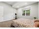 Relaxing bedroom with a large window and natural light, complete with exercise equipment for personal fitness at 6532 S Tempe St, Aurora, CO 80016