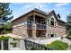 Multi-level home featuring stone accents, a balcony, and beautiful outdoor landscaping at 6532 S Tempe St, Aurora, CO 80016