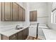 Functional laundry room with sink, countertop, cabinets, washer, and dryer at 6532 S Tempe St, Aurora, CO 80016